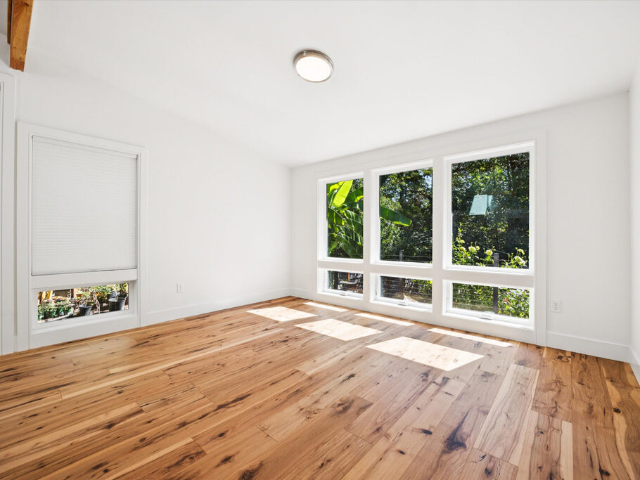 Contemporary attached ADU with large windows and hardwood floors.