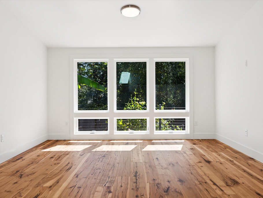Contemporary attached ADU with large windows and hardwood floors.