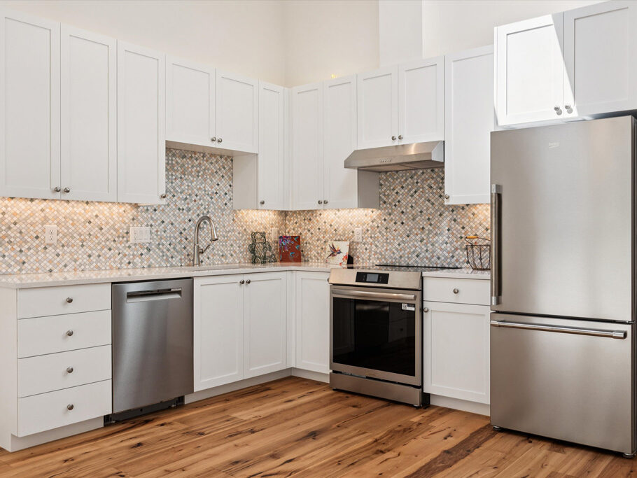 Beautiful kitchen in contemporary attached ADU with hardwood floors.