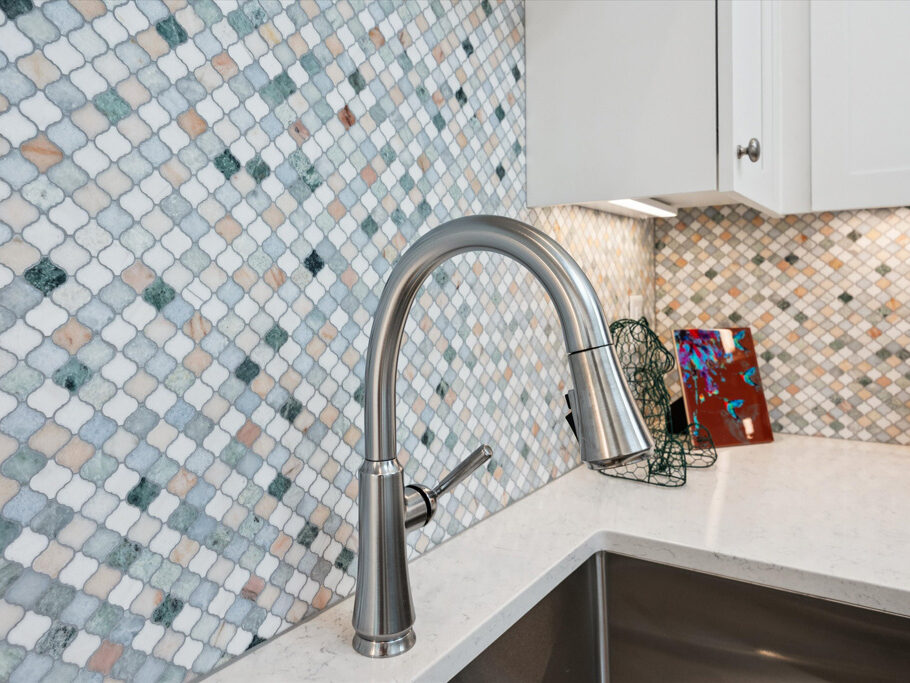 Kitchen faucet and tile detail in contemporary attached ADU.