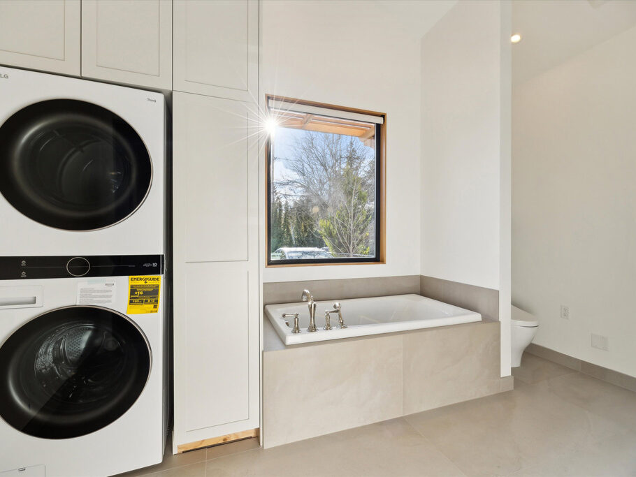 Luxurious bathroom with tub and laundry in detached ADU (accessory dwelling unit) on Knight Street in SE Portland, Oregon